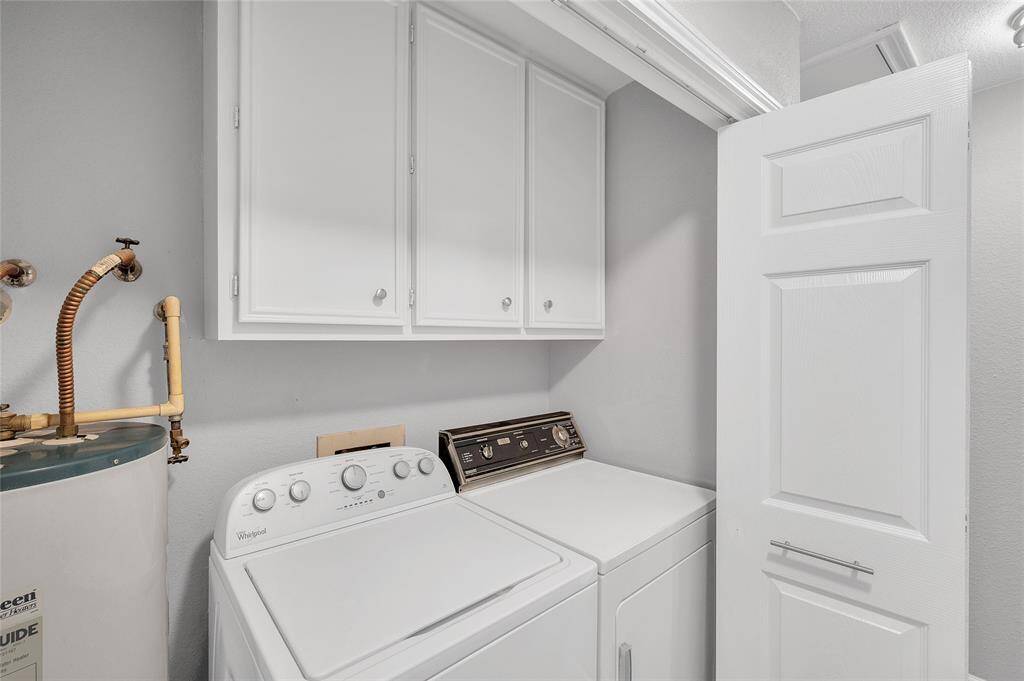 Cabinets add convenience in the utility room.