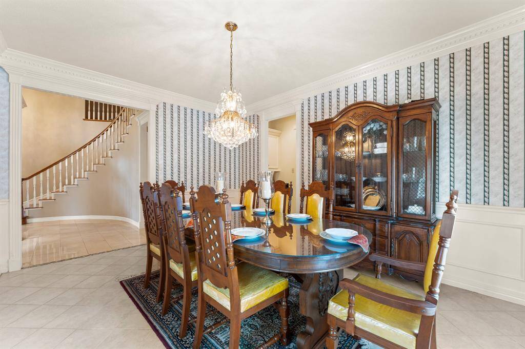 Spacious formal dining with a chandelier and lots of natural lighting