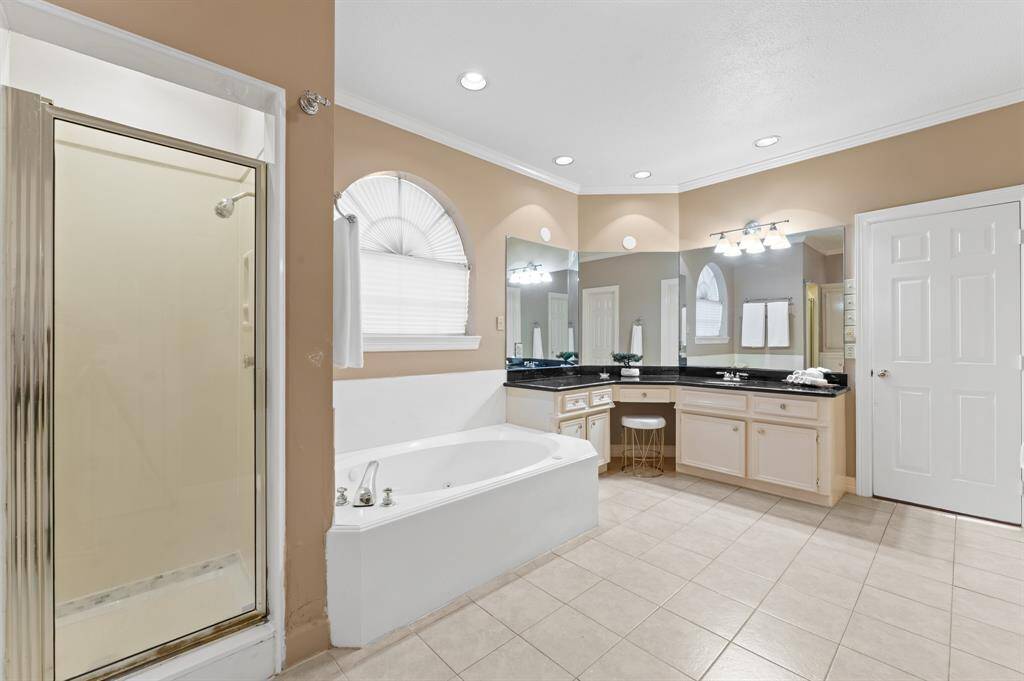 Spacious ensuite bathroom with seperate large shower and garden tub also has his and hers separate large closets one with a hidden cedar closet