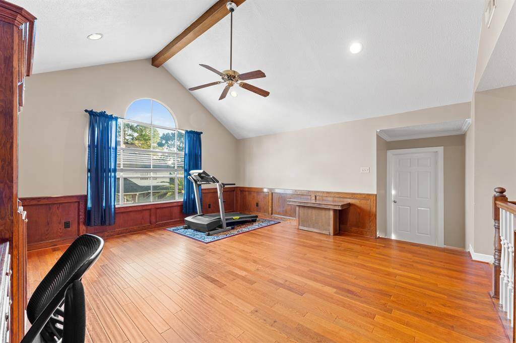 2nd floor large game/flex room with natural lighting and views of the backyard overlooking the pool