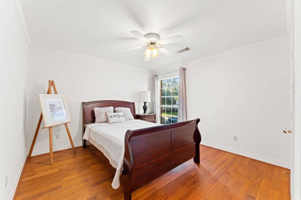 2nd floor bedroom #2 with beautiful views of the mature trees that adorn the front yard, oakwood flooring and a large walk in closet