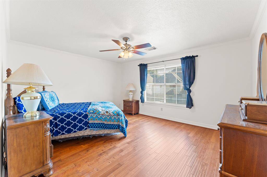 2nd floor bedroom #4 with large window for natural lighting, views of the backyard, oakwood flooring and a large walk in closet