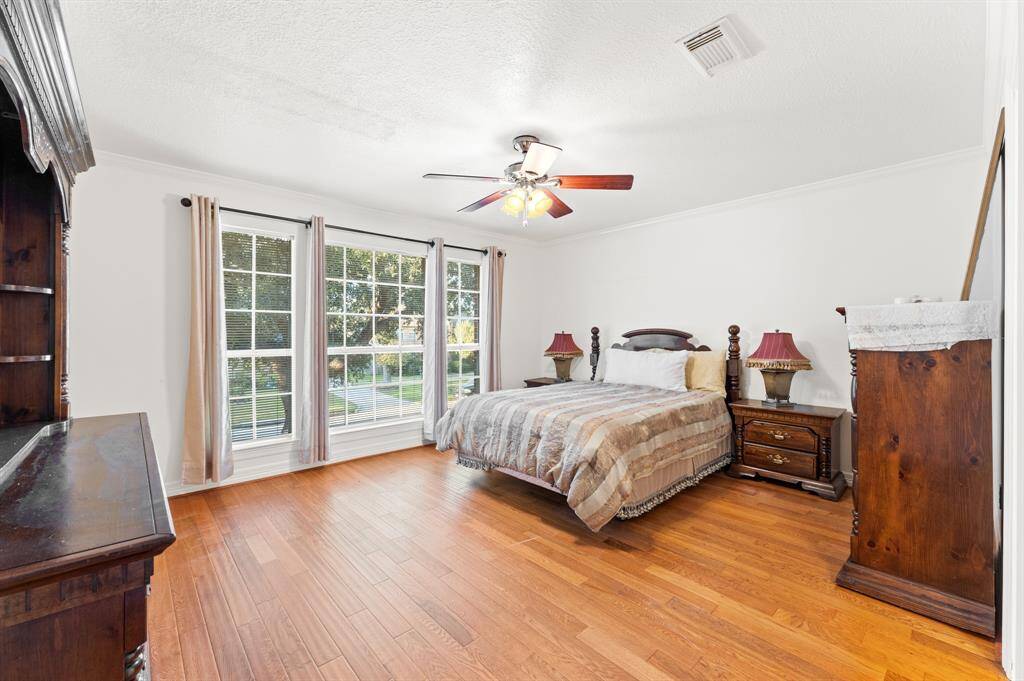 2nd floor bedroom #5 with large window for natural lighting, views of the front yard and mature trees, oakwood flooring and a large walk in closet