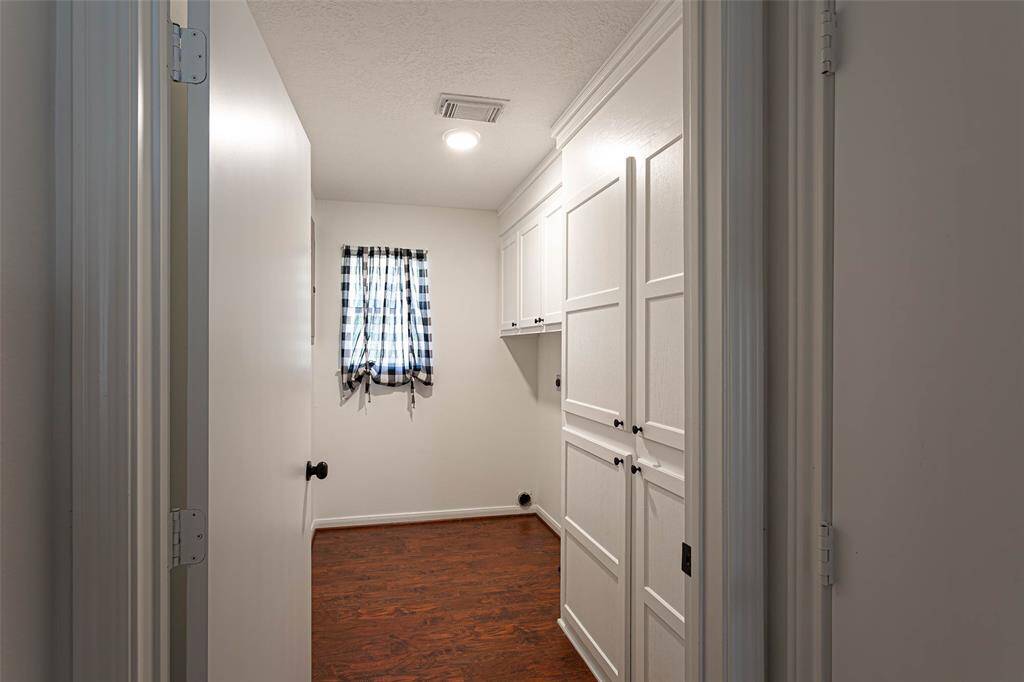 utillity room has storage space and laundry shoot into primary bath