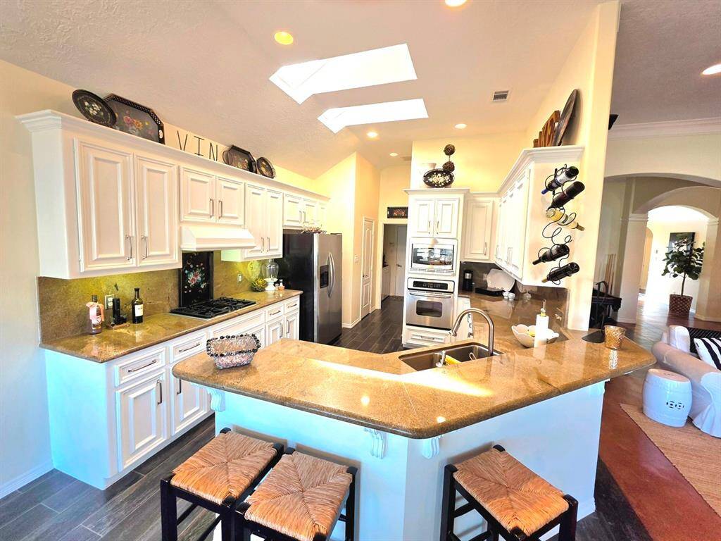 Very roomy kitchen with stainless steel appliances , lots of cabinets and beautiful granite countertops