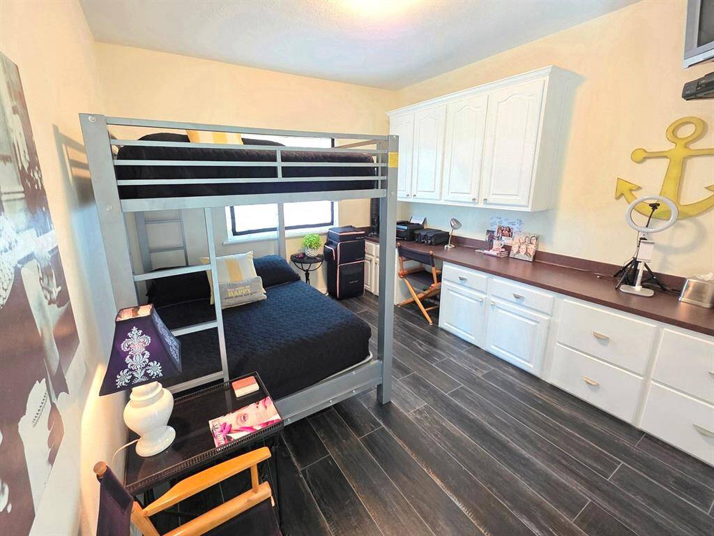 The third guest room is currently being used for both an office and extra bedding for guests