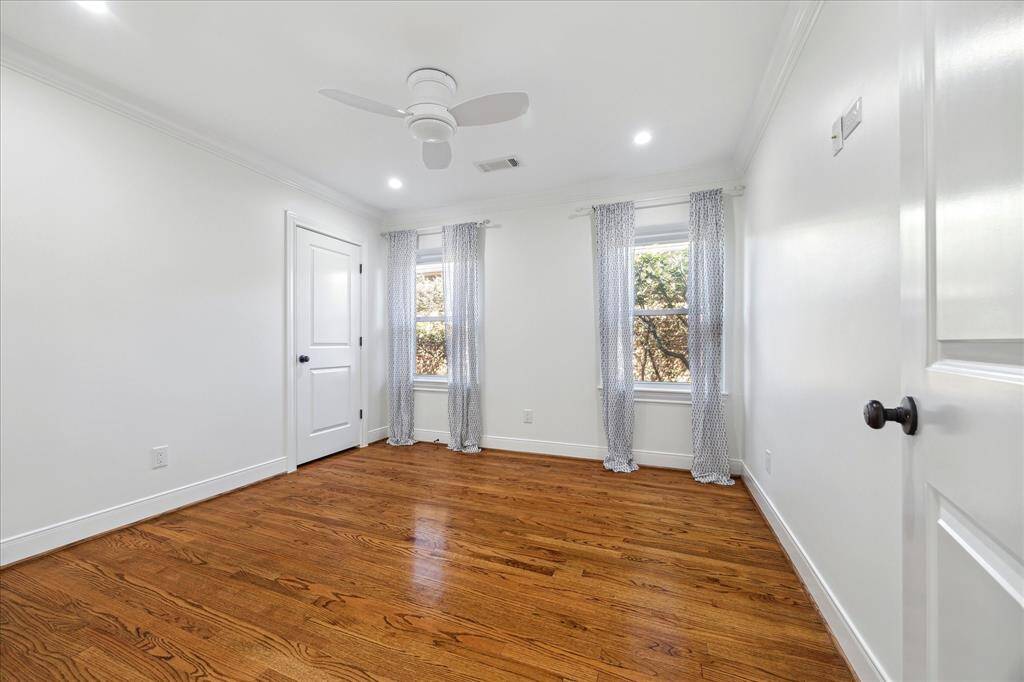Third bedroom with crown molding, custom closet system, recessed lighting and hard wired for wall mounted TV.