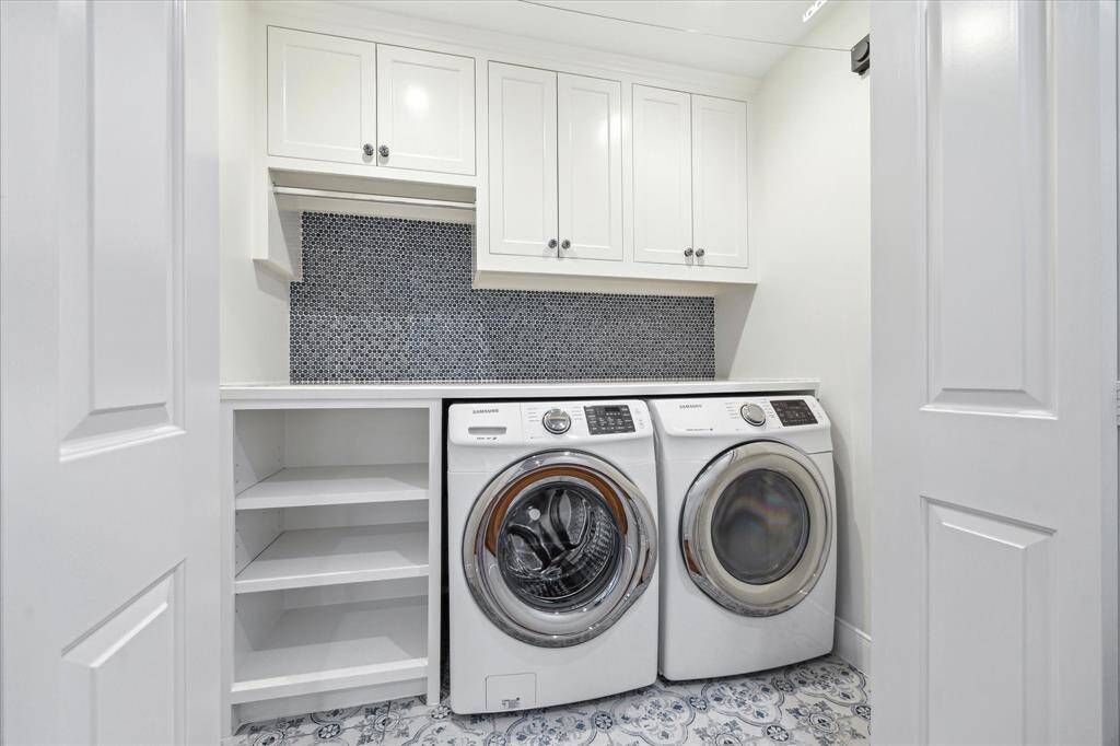 Amazing utility room in the house with designer finishes, quartzite marble countertop and built in shaker style inset cabinetry.
