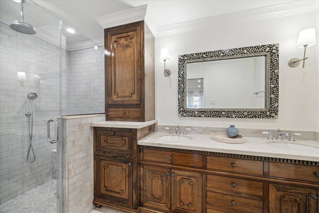 Designer worthy primary bathroom has a gorgeous custom vanity with dual sinks and quartzite counter, huge walk-in shower with marble tile, rainfall shower head plus handheld shower head, and private toilet area. All plumbing in house upgraded to PEX.