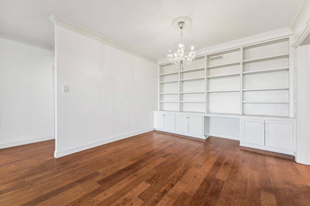 The dining area features custom-built shelving, cabinetry, and a desk for added functionality.