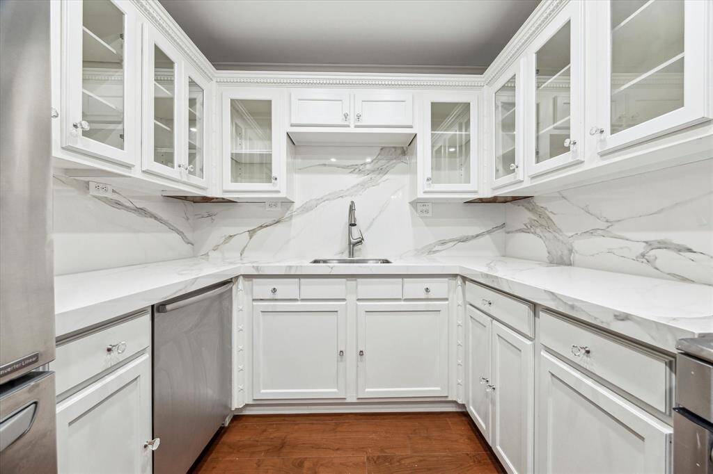Kitchen with porcelain countertops and backsplash.