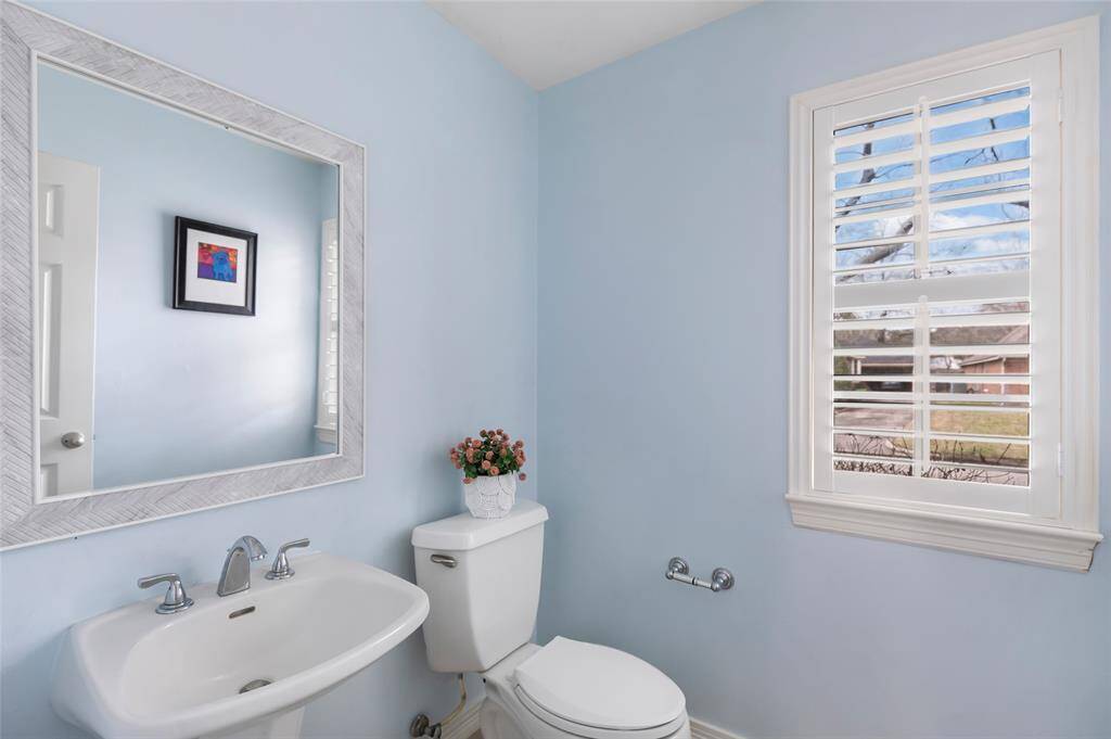 Spacious primary bathroom WITH new paint on cabinets and hardware...