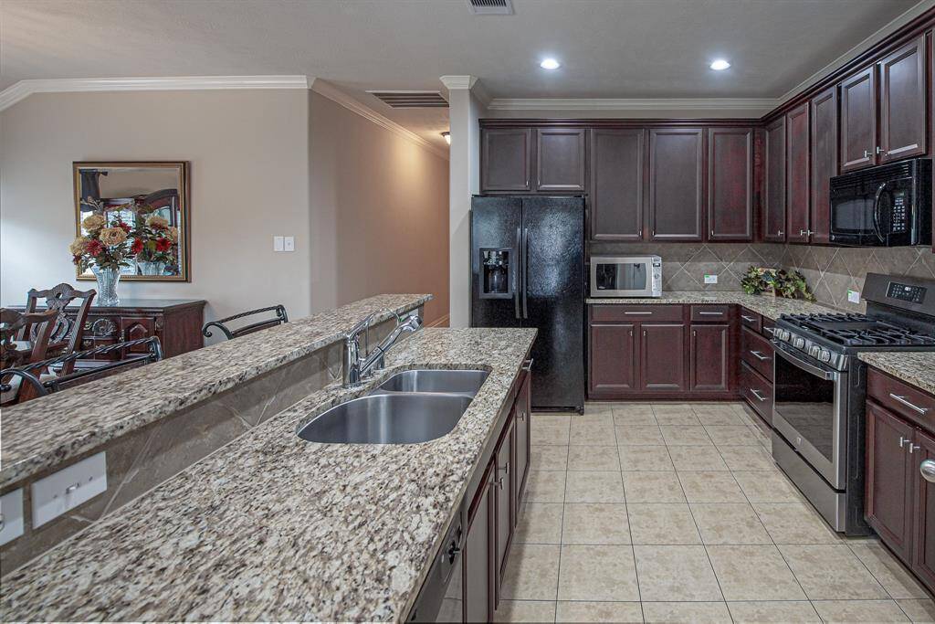 Open kitchen with granite countertops, recessed lighting and stainless steel appliances