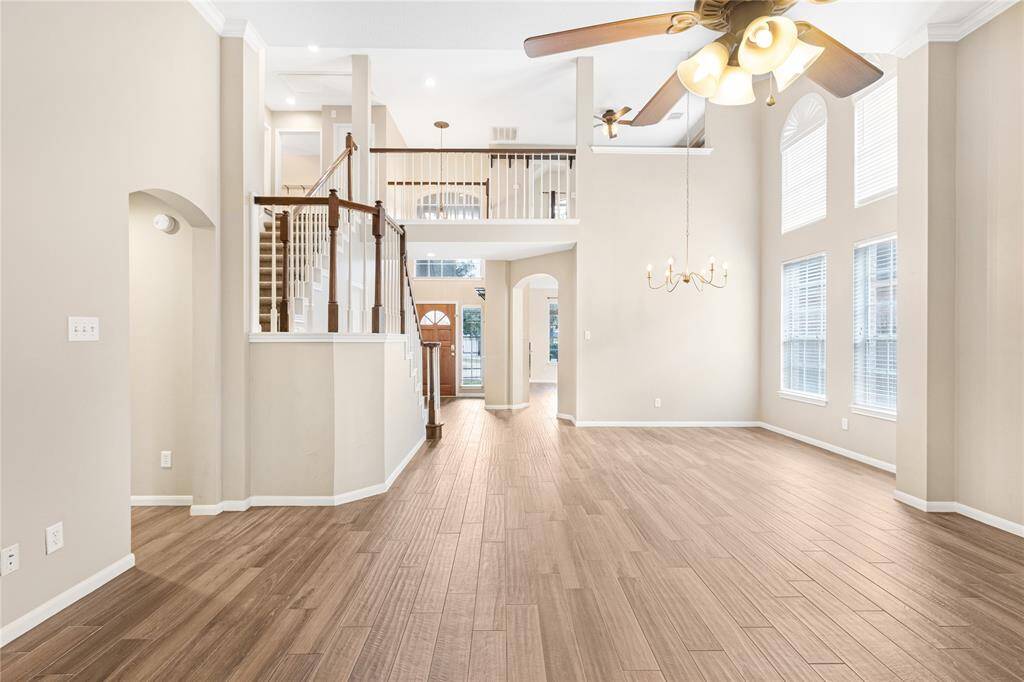 Spacious layout with high ceilings, ample natural light from large windows, elegant tile floors