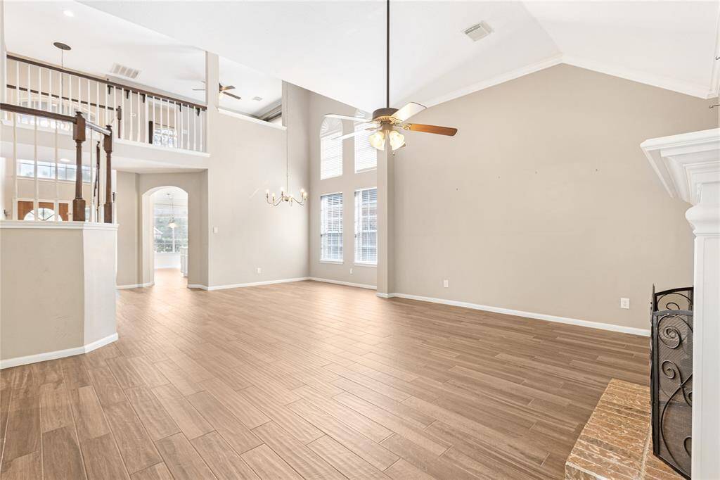 Oversized formal dining/living area with high ceilings, and an open second-story loft space.