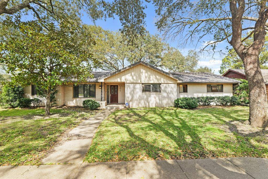 Charming Curb Appeal! This beautifully maintained 4-bedroom home sits on a spacious corner lot, featuring mature oak trees, a manicured lawn, and a welcoming entrance. Zoned to Bellaire!