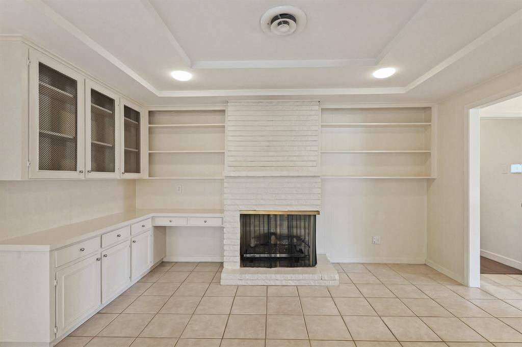 Expansive Den with Outdoor Access! Sliding doors lead to a landscaped backyard, filling the space with natural light.