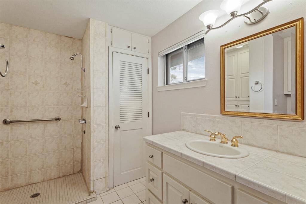 Updated Bathroom with Elegant Finishes! This bright and airy bathroom includes a stylish vanity, updated lighting, and Kohler fixtures.