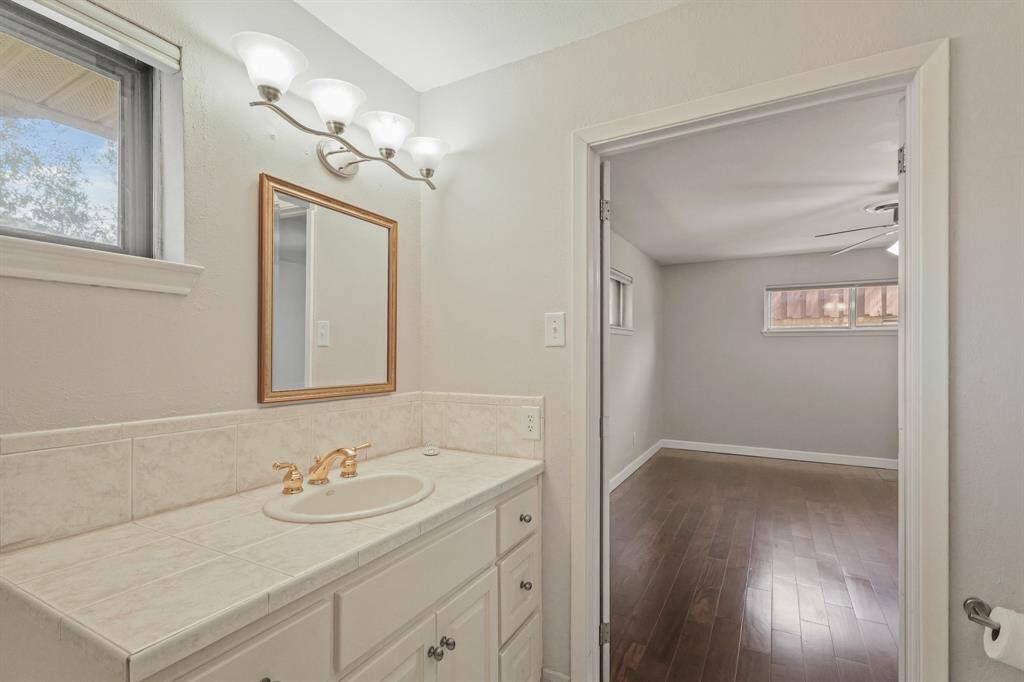 Primary bath vanity with gold tone fixtures.