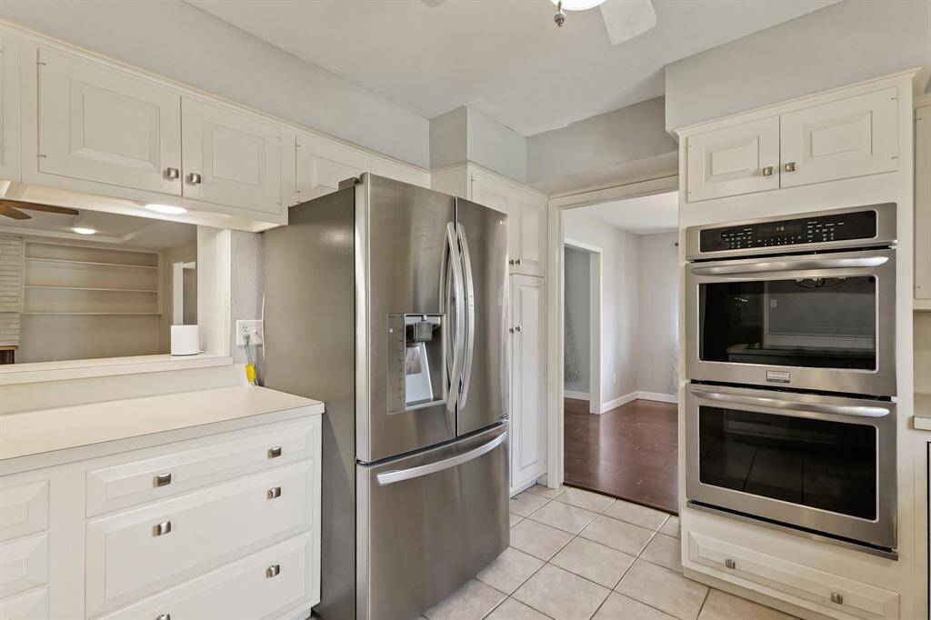 Chef’s Kitchen with Premium Updates! The kitchen boasts Woodmode cabinets, double ovens, a new cooktop, and stainless steel appliances.
