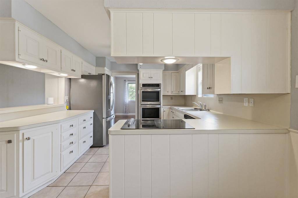 Modern and Functional Kitchen! Plenty of counter space, storage, and a stainless steel fridge included—perfect for any home cook.