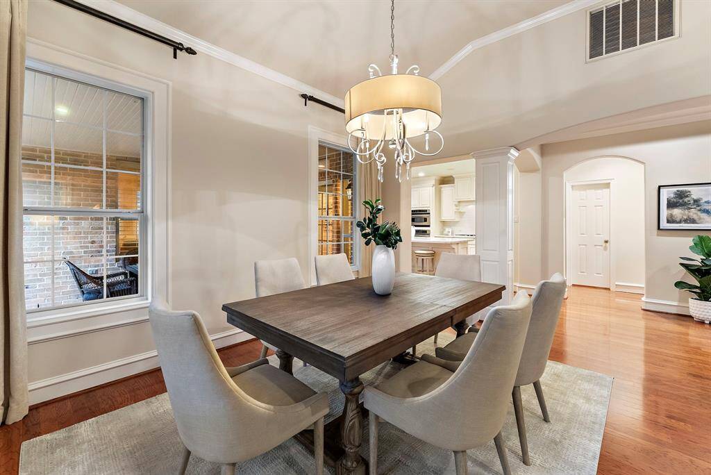 The dining area offers ample room for gatherings, with hardwood flooring and easy access to the kitchen, making it both stylish and practical.