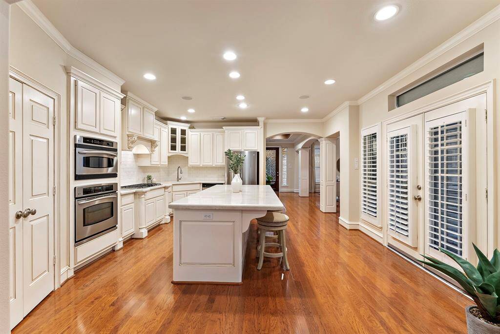 Discover the heart of the home in this remodeled kitchen. The spacious open layout flows effortlessly, with french doors leading to a charming outdoor patio, where you can enjoy your mornings while natural light fills the space, enhancing the connection to outdoor views.