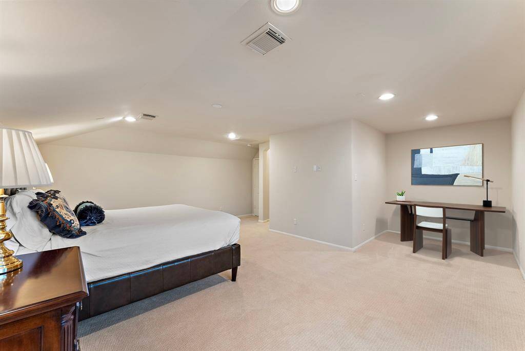 This spacious secondary primary bedroom offers plenty of room for a cozy seating area, office, or whatever suits your lifestyle, providing flexibility to adapt the space to your needs. This photo has been virtually staged.