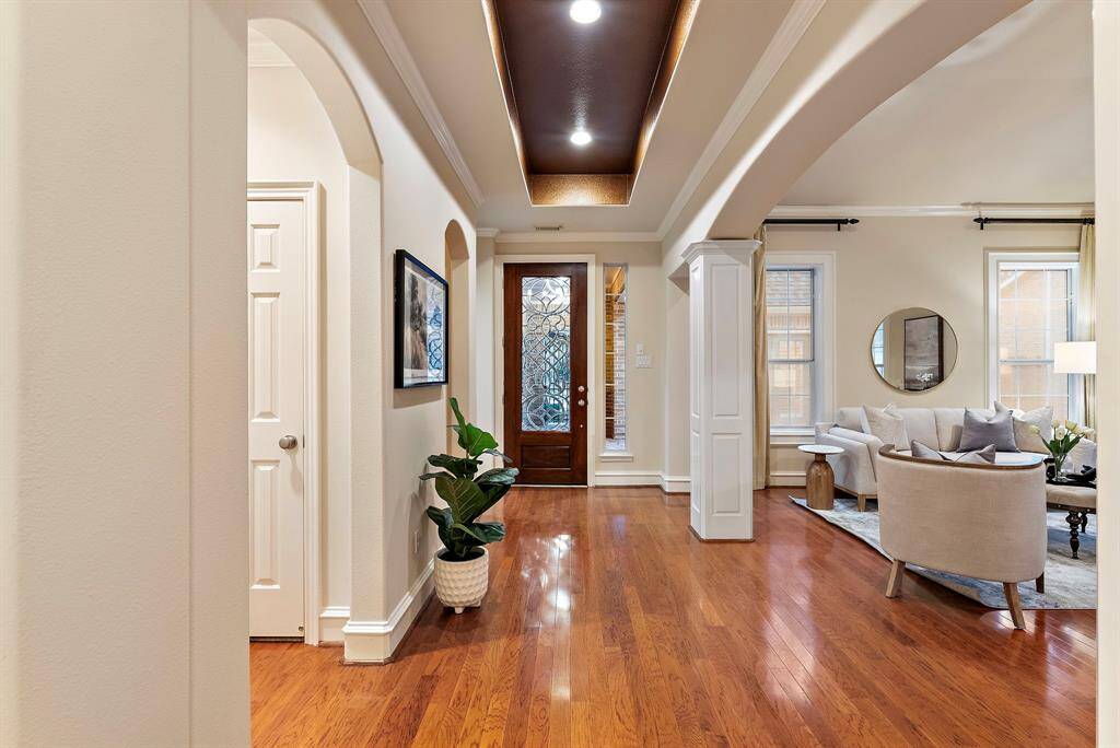 The entryway flows effortlessly into the formal living room, creating an open, light-filled space perfect for welcoming guests.