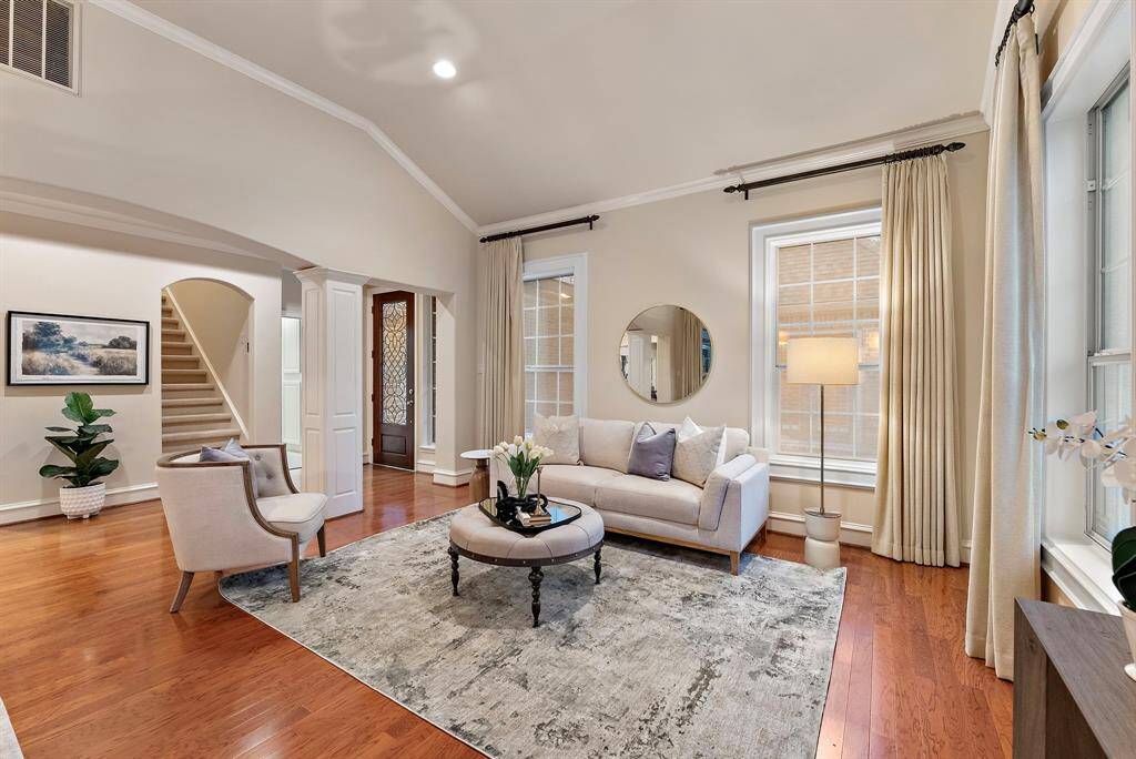 The formal living area features high ceilings and expansive windows throughout, offering an ideal setting for relaxation and entertaining.