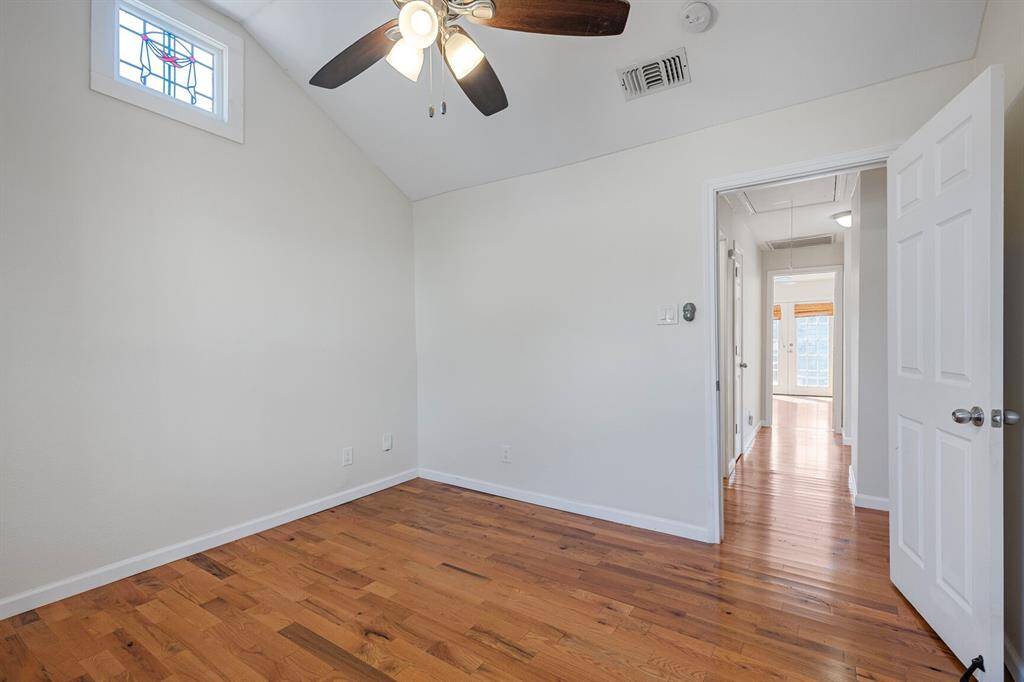The front-facing second bedroom features a stunning stained glass window.