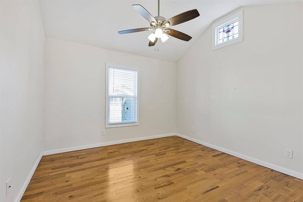 Spacious second bedroom with elegant vaulted ceiling.