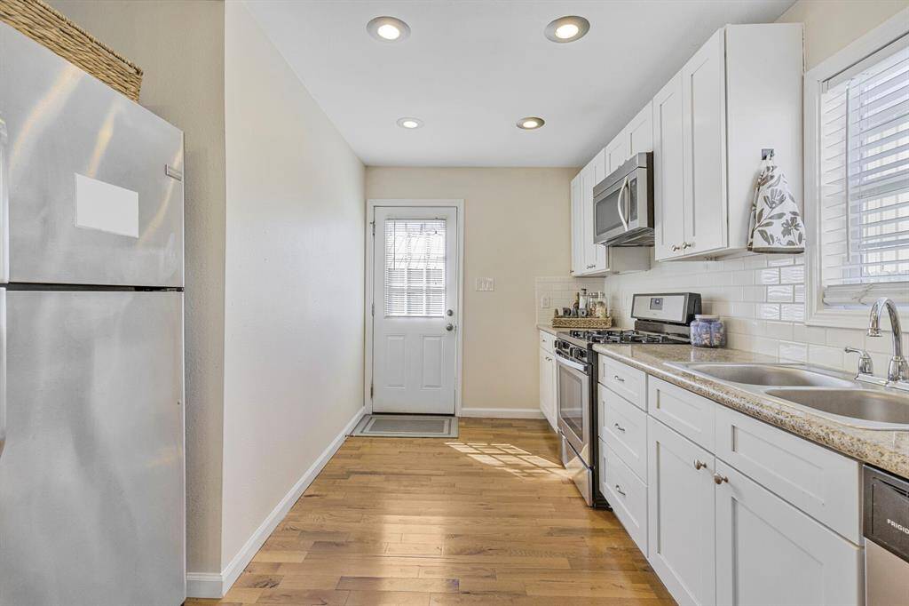 Enjoy seamless indoor-outdoor living with direct kitchen access to your inviting wood deck.