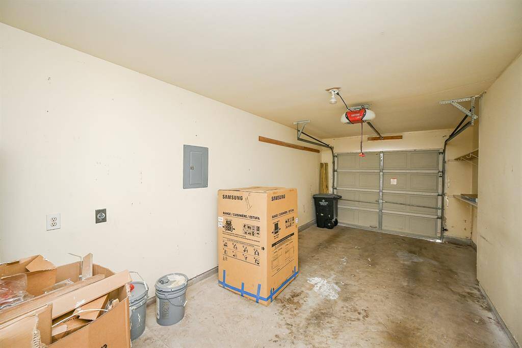 The bathroom features a combination tub, shower with white tile, and marble countertops with plenty of space.