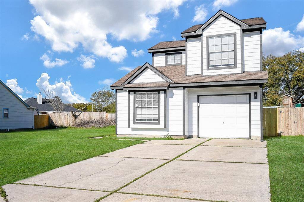This home features a single-car garage and a neatly landscaped front yard