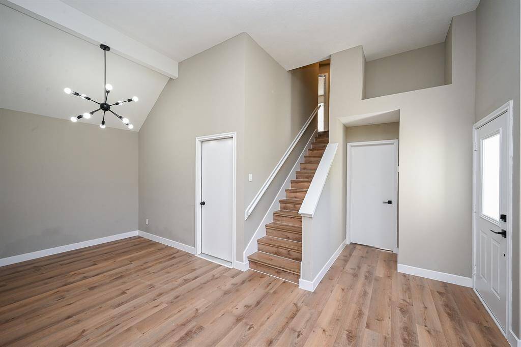 The well-maintained lawn and concrete driveway enhance the curb appeal.