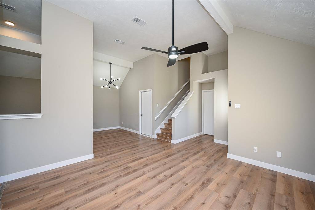 This space offers an open layout and a striking staircase that leads to the upper level.