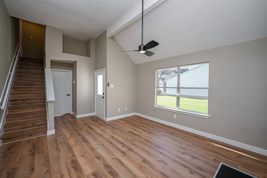 This kitchen has modern hardware and a full suite of stainless steel appliances.