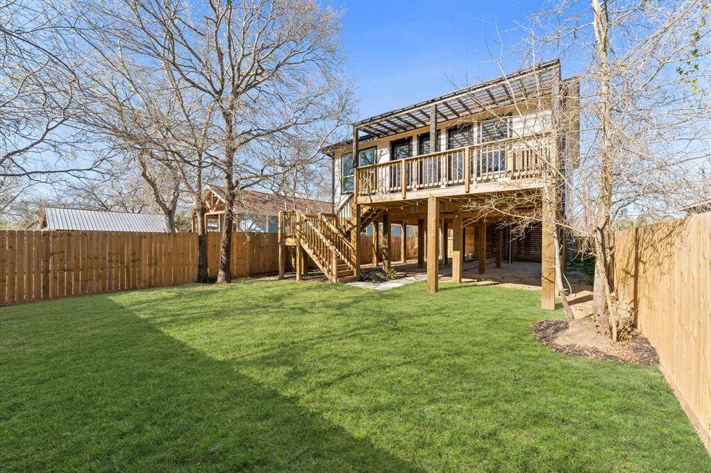 Enjoy shaded outdoor living with a spacious patio area perfect for dining, lounging, or entertaining guests.