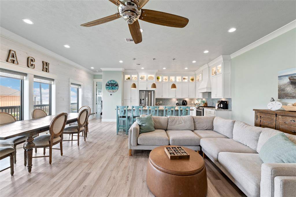 Designed for both relaxation and entertainment, the open family room offers plush seating, high ceilings, and panoramic windows that showcase the stunning surroundings