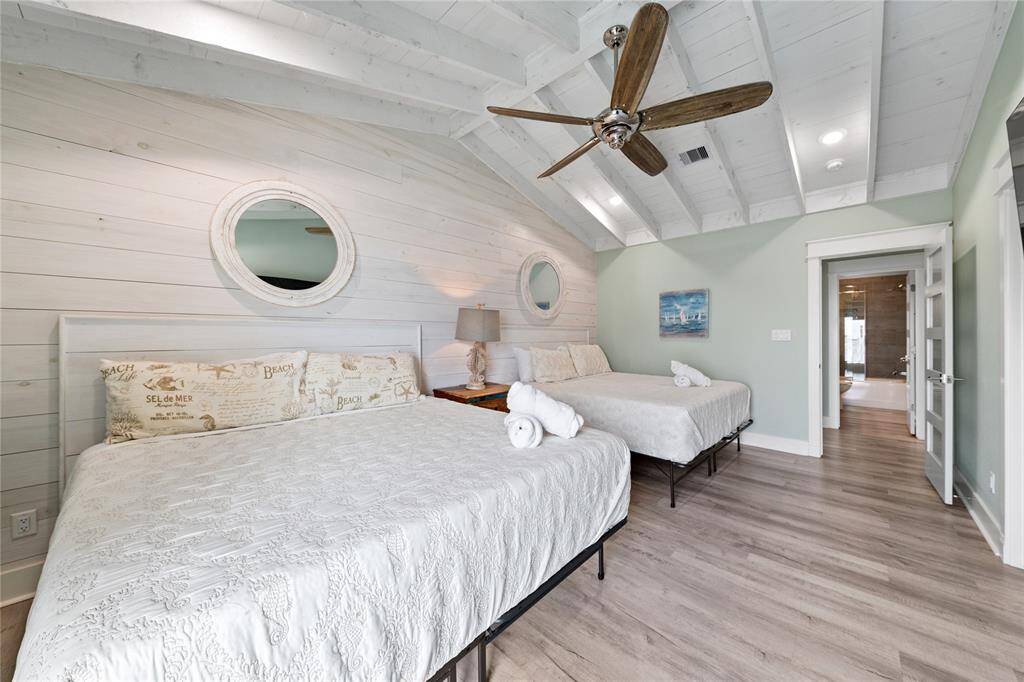 This generously sized secondary bedroom suite upstairs comfortably fits two king-sized beds, making it perfect for family or guests. With ample space and stylish design, it offers both luxury and functionality.