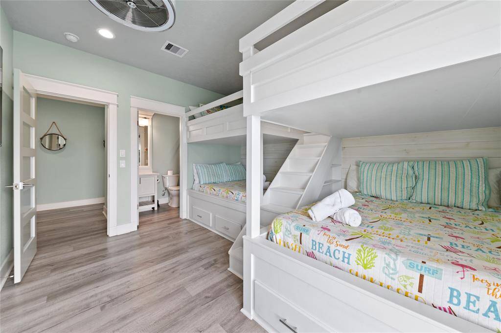 The built-in bunk beds in this cozy secondary bedroom maximize space while offering comfort and fun for everyone. Just steps away, the ensuite bath ensures convenience and privacy for all.