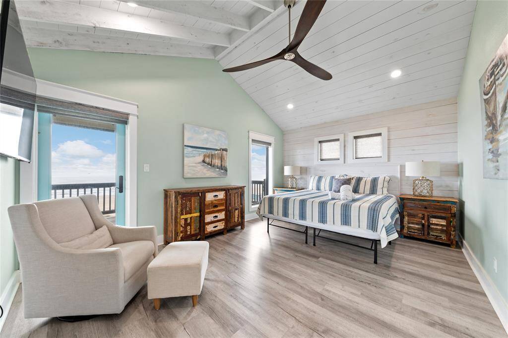 This upstairs primary suite offers both privacy and luxury, featuring a huge walk-in shower with dual rain shower heads. Enjoy the serene coastal views from your private access to the upper-level wraparound deck, making every moment feel like a retreat.