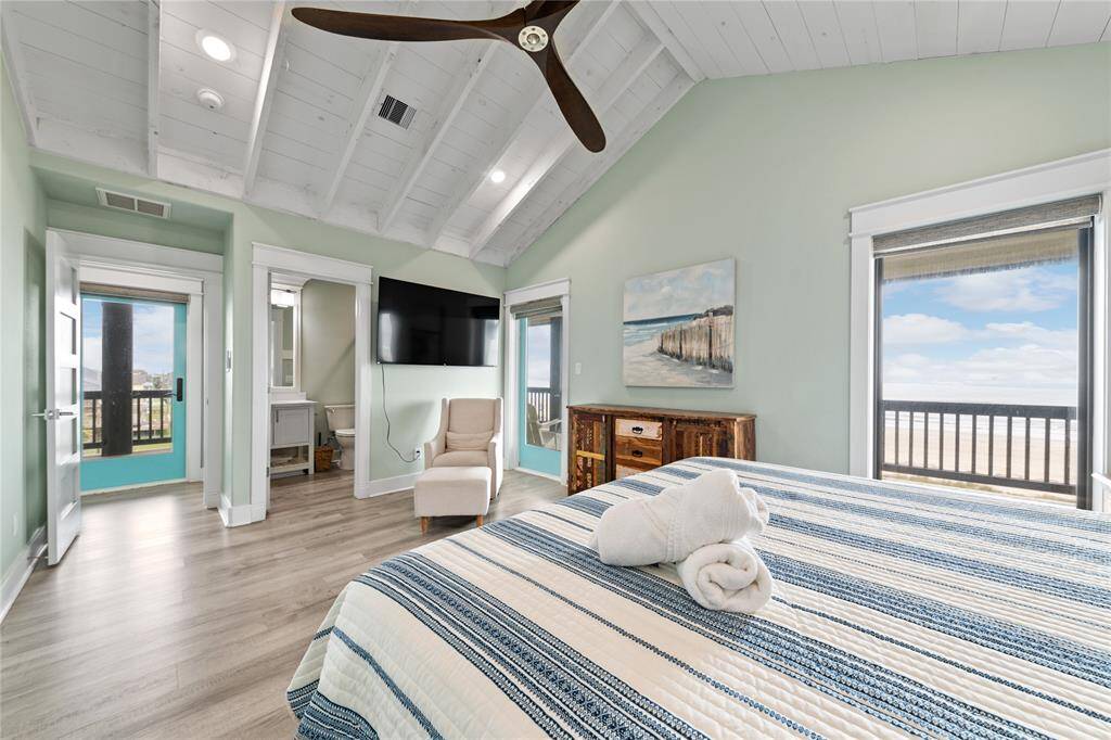This upstairs primary suite offers the perfect blend of luxury and nature with private access to the wraparound deck