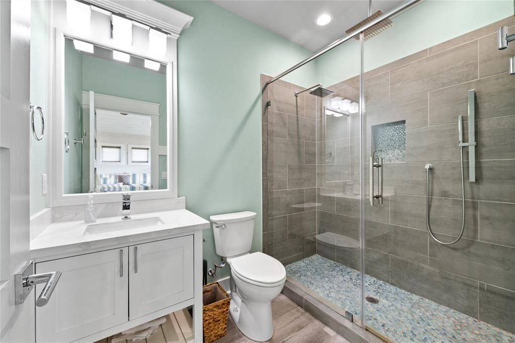 Inside, a massive walk-in shower with dual rain shower heads provides the ultimate relaxation, making this space the perfect escape.