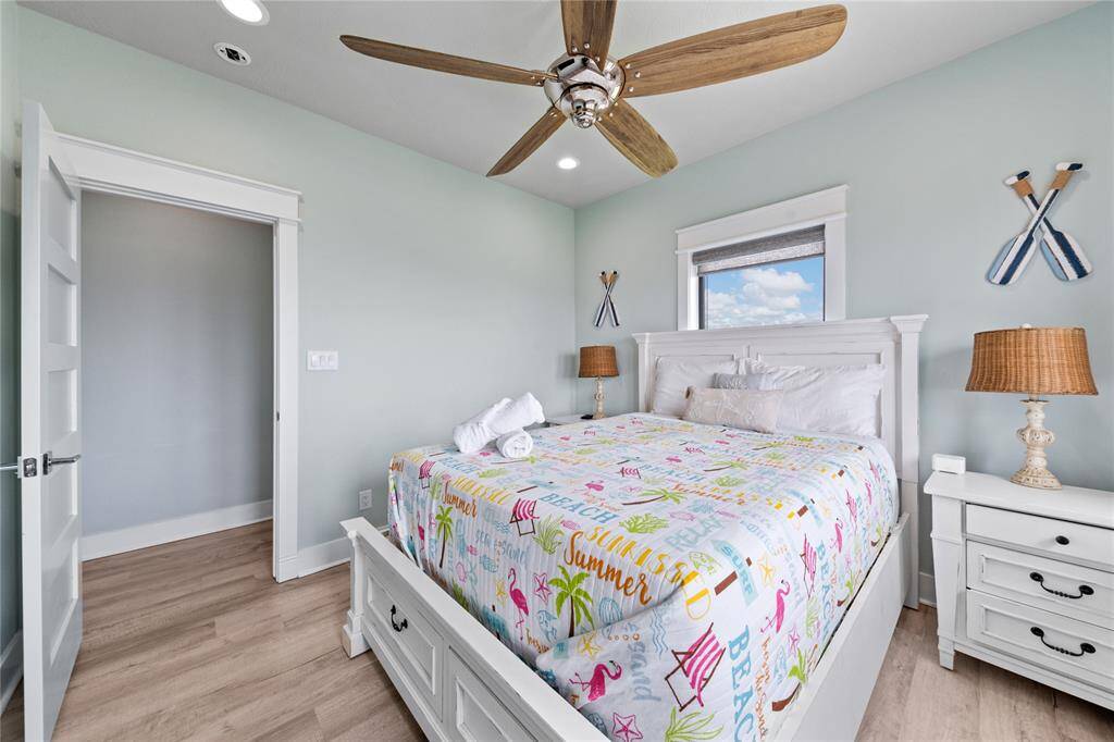 This beautifully appointed secondary bedroom is a perfect getaway, with coastal-inspired decor, plenty of natural light, and a comfortable layout that makes it ideal for restful nights or playful days.