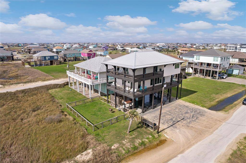 Relax and unwind on two spacious wraparound porches, offering panoramic ocean views and the perfect place to enjoy the coastal breeze. These expansive decks provide ample space for outdoor dining, morning yoga, or simply soaking in the sights and sounds of the Gulf.