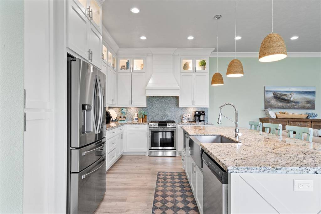 The sleek, modern design pairs beautifully with the stainless steel appliances and custom cabinetry.