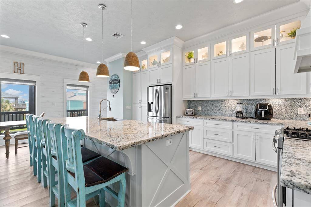 This chef’s kitchen is a masterpiece, featuring quartz countertops, stainless steel appliances, and a massive island with bonus seating—perfect for gathering with family and friends.