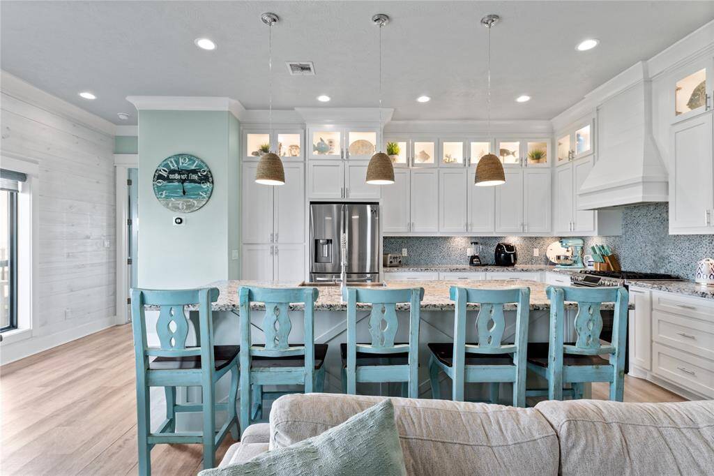 Outfitted with stainless steel appliances, a drawer microwave, and a gas range, this kitchen is designed for both everyday convenience and gourmet cooking experiences.